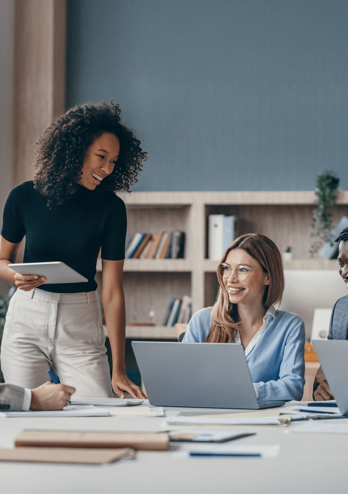 Happy group of business people discussing strategy during team meeting at the office desk together